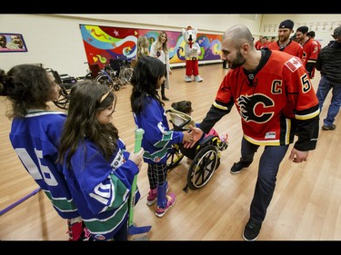 Calgary Flames captain Mark Giordano shakes hands with the Townsend Tigers after an annual wheelchair floor hockey game between the Townsend Tigers and the Flames at the Alberta Children's Hospital in Calgary, Alta., on Tuesday, Jan. 31, 2017. The Townsend Tigers, made up of kids who attend Dr. Gordon Townsend School at the hospital, beat the Flames for the 36th year in a row, this year by a 15-0 score. Lyle Aspinall/Postmedia Network