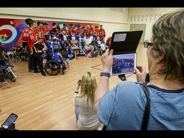 A group photo is staged after an annual wheelchair floor hockey game between the Townsend Tigers and the Calgary Flames at the Alberta Children's Hospital in Calgary, Alta., on Tuesday, Jan. 31, 2017. The Townsend Tigers, made up of kids who attend Dr. Gordon Townsend School at the hospital, beat the Flames for the 36th year in a row, this year by a 15-0 score. Lyle Aspinall/Postmedia Network
