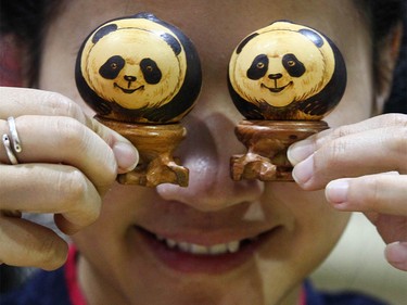 A vendor shows off panda toys during Chinese Lunar New Year celebrations in downtown Calgary, Alta at the Chinese Cultural Centre on Saturday January 28, 2017. Jim Wells/Postmedia