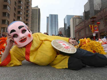 A performer relaxes in the street during Chinese Lunar New Year celebrations in downtown Calgary, Alta at the Chinese Cultural Centre on Saturday January 28, 2017. Jim Wells/Postmedia