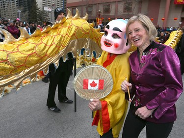 Alberta Premier Rachel Notley poses with a performer after participating in the traditional eye-dotting ceremony during Chinese Lunar New Year celebrations in downtown Calgary, Alta at the Chinese Cultural Centre on Saturday January 28, 2017. Jim Wells/Postmedia