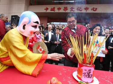 Calgary Mayor Naheed Nenshi (L) lights incense during Chinese Lunar New Year celebrations in downtown Calgary, Alta at the Chinese Cultural Centre on Saturday January 28, 2017. Jim Wells/Postmedia