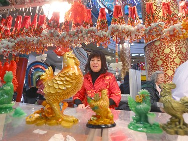 A vendor prepares decorations in the year of the Rooster during Chinese Lunar New Year celebrations in downtown Calgary, Alta at the Chinese Cultural Centre on Saturday January 28, 2017. Jim Wells/Postmedia