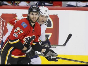 The Calgary Flames' Michael Frolik celebrates scoring on San Jose Sharks goaltender Aaron Dell at the Scotiabank Saddledome in Calgary on Wednesday, Jan. 11, 2017. (Gavin Young)