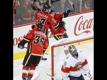 Troy Brouwer, Sean Monahan and Kris Versteeg of the Calgary Flames celebrate Versteeg's first-period goal near Florida Panthers goalie Roberto Luongo during NHL action in Calgary, Alta., on Tuesday, Jan. 17, 2017. Lyle Aspinall/Postmedia Network