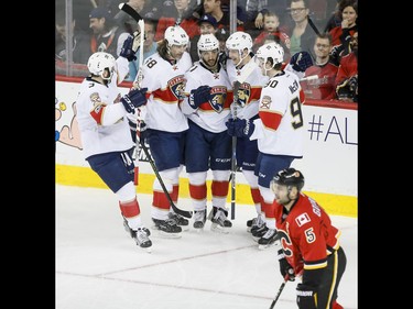 Keith Yandle, Jaromir Jagr, Vincent Trocheck, Mark Pysyk and Jared McCann of the Florida Panthers celebrate a goal near Mark Giordano of the Calgary Flames during NHL action in Calgary, Alta., on Tuesday, Jan. 17, 2017. Lyle Aspinall/Postmedia Network