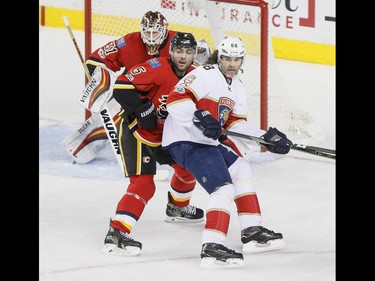 Jaromir Jagr of the Florida Panthers and Mark Giordano of the Calgary Flames eye a play in front of goalie Chad Johnson during NHL action in Calgary, Alta., on Tuesday, Jan. 17, 2017. Lyle Aspinall/Postmedia Network