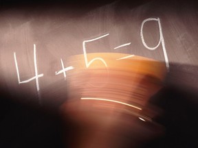 Local Input~ Hand erasing math equation on blackboard. Getty Images
FOR NATIONAL POST USE ONLY