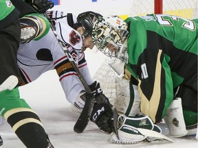 Mark Kastelic of the Calgary Hitmen braces for impact in front of Prince Albert goalie Nicholas Sanders at Scotiabank Saddledome on Sunday, Jan. 22, 2017. (Lyle Aspinall)