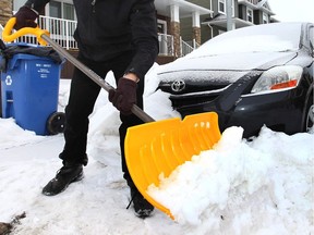 Matt Jeppesen was busy still shovelling snow in the community of Redstone in Calgary on Monday December 16, 2013. Darren Makowichuk/Calgary Sun/QMI Agency