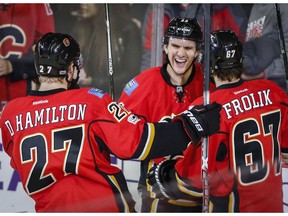Calgary Flames' Mikael Backlund, centre, from Sweden, celebrates his first goal with teammates against the Florida Panthers in Calgary on Tuesday, Jan. 17, 2017. (Jeff McIntosh/The Canadian Press)