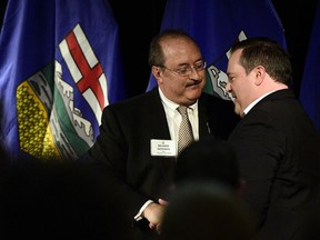 The Honourable Jason Kenney is welcomed onto the stage by Richard Gotfried, MLA Calgary-Fish Creek as Kenney hosted a town hall meeting as part of his Unite Alberta Truck Tour at the Hotel Blackfoot SE Calgary on January 11. The event was packed with supporters overflowing into a second room with a live feed. RYAN MCLEOD FOR POSTMEDIA CALGARY