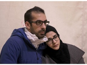 A young couple listens to a speaker during prayers for Quebec City Mosque event  held at the Akram Jomaa Center in northeast Calgary.