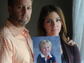 Rod and Jennifer O'Brien stand holding a photo of their five-year-old son Nathan at their SW Calgary, Alta. home on Tuesday October 28, 2014. Nathan along with his grandparents Kathy and Alvin Likness were taken from from their SW Calgary home in June and have yet to be found. The family has announced foundation to help benefit children in Nathan's name. Stuart Dryden/Calgary Sun/QMI Agency