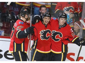 Calgary Flames' Mikael Backlund (centre) celebrates his second period goal against the Colorado Avalanche at the Scotiabank Saddledome in Calgary on Wednesday, Jan. 4, 2017. (Jim Wells)
