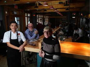 Kevin Yang, left, Kirk Shaw, middle, and Jackie Cooke at Provision restaurant in Calgary.