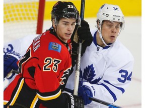 Calgary Flames' Sean Monahan battles against Auston Matthews of the Toronto Maple Leafs in Calgary on Nov. 30, 2016. (Al Charest)