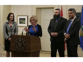Premier Rachel Notley (at podium) created a new government department for child services when she announced a cabinet shuffle Thursday afternoon January 19, 2017 at Government House in Edmonton. Danielle Larivee (left), who started the day as minister of municipal affairs, is now in charge of the new children's services ministry. The move spins off child welfare responsibilities from the human services department and leaves minister Irfan Sabir (right) in charge of a renamed community and social services department. Notley named a new minister, Shaye Anderson (second from right), MLA for Leduc-Beaumont, to cabinet. He takes over the municipal affairs portfolio and will join Larivee on the Municipal Governance Committee.