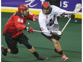 Roughnecks Scott Carnegie, left, battles Stealth Corey Small during National Lacross League game action between the Vancouver Stealth and the Calgary Roughnecks at the Scotiabank Saddledome in Calgary on Friday January 6, 2017.