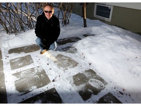 Alan Zakrison and his collection of old sidewalk stamps outside his home in Calgary, Alta., on Wednesday January 4, 2017.