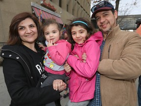 Husband and wife Khalid Al-Zubaidi and Athba Samarai are joined by their daughters Maryan and Dimi as they speak outside the US consulate in downtown Cagary, Alta on Sunday January 29, 2017.  The Iraqi family is concerned about relatives and had to change their plans to travel to the middle east to visit. They joined about 50-75 protesters who gathered to voice their opinions over the proposed muslim ban.Jim Wells/Postmedia