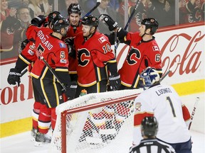 Calgary Flames playersv celebrate a Kris Versteeg goal near Florida Panthers goalie Roberto Luongo during NHL action in Calgary on Jan. 17, 2017.