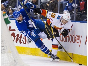 Toronto Maple Leafs' Martin Marincin goes into the boards with Calgary Flames' Matthew Tkachuk at the Air Canada Centre on Monday, Jan. 23, 2017. (Ernest Doroszuk)