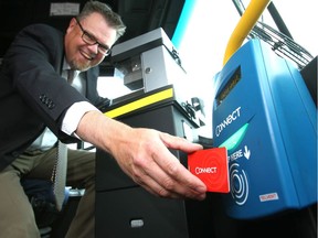 Calgary Transit director Doug Morgan is seen with the electronic fare collection system that was abandoned in 2015.