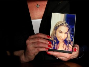 Trena Patterson holds a photo of her daughter who was killed in a police shooting on November 29, 2016 in Calgary, Alta. Leah Hennel/Postmedia