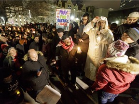 A throng gathers during a candlelight vigil outside of City Hall in downtown Calgary, Alta., on Monday, Jan. 30, 2017. Several hundred people of various faiths gathered for a candlelight vigil, to show support for the Muslim community in the wake of a Quebec City shooting inside a mosque the day before. Lyle Aspinall/Postmedia Network