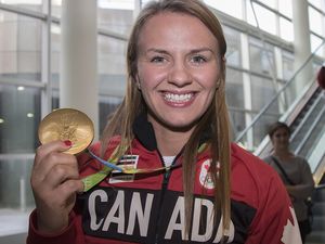CALGARY, AB -- Rio Olympic gold medal wrestler Erica Wiebe returns to Calgary and is greeted by family, friends and fans at the Air Canada arrivals terminal, on August 26, 2016. -- (Crystal Schick/Postmedia) (For story by ) 20075936A ORG XMIT: POS1608262125275847