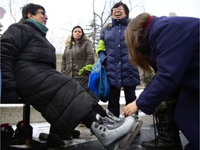 Zoe Anderson helps Jaya Dharan tie her skates. Dharan has been both a mentor and mentee with CRIEC as the organization spent time with the mentors and mentees of their group celebrating January Mentoring Month on January 23. RYAN MCLEOD FOR POSTMEDIA CALGARY