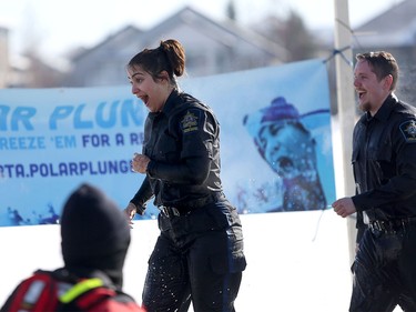Sandeep Manhas, left, with Calgary Remand Centre, reacts to the cold water after taking the icy dip during the Polar Plunge Calgary on Saturday February 25, 2017, in support of Special Olympics. Leah Hennel/Postmedia