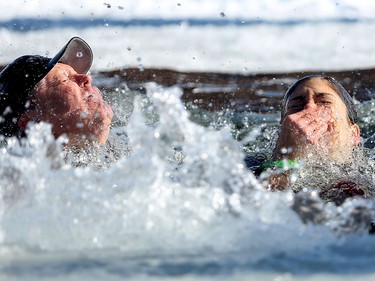 Members of team Tsuu T'ina Police Blue Bloods take an icy dip during the Polar Plunge Calgary on Saturday February 25, 2017, in support of Special Olympics. Leah Hennel/Postmedia
