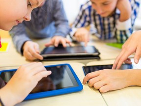 Local Input~ education, elementary school, learning, technology and people concept - close up of school kids with tablet pc computers having fun and playing on break in classroom  // 1102 ar sleepy kids