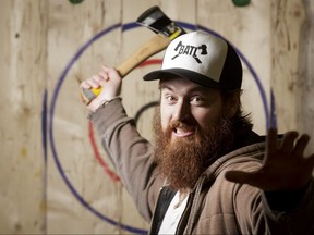 Graham Mackenzie mugs for an axe-throwing portrait at BATL in Calgary, Alta., on Saturday, Feb. 18, 2017. He was promoting the all-ages Punk Rock Axe Throwing event set for the next day. Lyle Aspinall/Postmedia Network