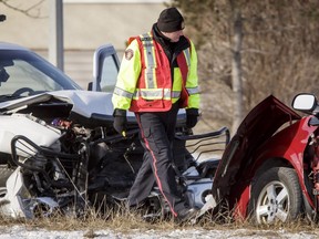 Police work at the scene of a crash between a pickup and a minivan on Edmonton Trail near Greenview Drie NE in Calgary, Alta., on Tuesday, Feb. 28, 2017.