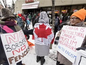 Demonstrators gather outside of the U.S. Consulate General office in downtown Calgary, Alta., on Saturday, Feb. 4, 2017. About 50 people gathered to show opposition to Islamophobia and anti-immigration sentiments. Lyle Aspinall/Postmedia Network