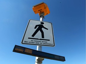 A pedestrian crossing is shown at Crowchild Tr and Shaganappi Tr in northwest Calgary, Alta on Saturday July 18, 2015. After a successful pilot, a city committee will recommend adopting Rectangular Rapid Flashing Beacon's at pedestrian crossings. The beacon is shown below the sign and is activated when the pedestrian presses a button to cross the intersection. Jim Wells/Calgary Sun/Postmedia Network