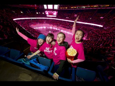 St. Joan of Arc School students (L-R) Taryn Grolla, Brooke Zaseybida, Julian Lester and Camila Munoz Diaz cheer on the first-ever BE BRAVE Anti-Bullying Game, a regular-season WHL tilt between the Calgary Hitmen and Brandon Wheat Kings, in Calgary, Alta., on Wednesday, Feb. 22, 2017. More than 8,000 students from Calgary and area were bussed to the morning game as part of Pink Shirt Day, enjoying concourse activities and special entertainment in addition to the regular-season game. Lyle Aspinall/Postmedia Network
