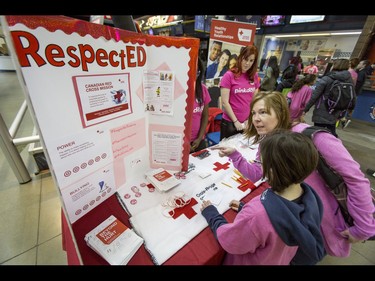 Holly Bartzis and her mom Corine Bartzis check out a Canadian Red Cross while attending the first-ever BE BRAVE Anti-Bullying Game, a regular-season WHL tilt between the Calgary Hitmen and Brandon Wheat Kings, in Calgary, Alta., on Wednesday, Feb. 22, 2017. More than 8,000 students from Calgary and area were bussed to the morning game as part of Pink Shirt Day, enjoying concourse activities and special entertainment in addition to the regular-season game. Lyle Aspinall/Postmedia Network