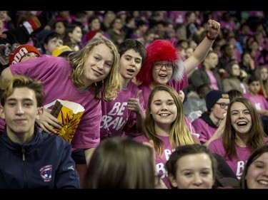 Students mug for the camera during the first-ever BE BRAVE Anti-Bullying Game, a regular-season WHL tilt between the Calgary Hitmen and Brandon Wheat Kings, in Calgary, Alta., on Wednesday, Feb. 22, 2017. More than 8,000 students from Calgary and area were bussed to the morning game as part of Pink Shirt Day, enjoying concourse activities and special entertainment in addition to the regular-season game. Lyle Aspinall/Postmedia Network