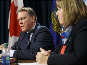 FILE PHOTO: Dave Mowat, president and CEO of ATB Financial, and Marg McCuaig-Boyd, Energy Minister, speak about Mowat's appointment as head of a royalty review advisory panel in this file photo.