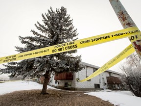 Police tape blocks access to a duplex at the corner of 75 St and 41 Ave NW in Calgary on Monday, Feb. 20, 2017. Police were apparently investigating the death of a person found there the day before.