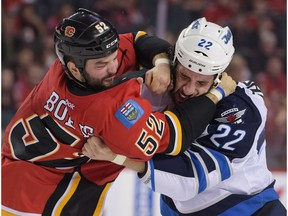 Brandon Bollig and Chris Thorburn of the Winnipeg Jets duke it out in a pre-season game at the Scotiabank Saddledome in Calgary, Alta., on Sunday, Oct. 2, 2016.