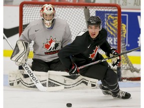 Brandon Hickey skates past goalie Samuel Montembault during Hockey Canada's National Teams' Summer Showcase at Winsport in Calgary on Aug. 1, 2015. (Lyle Aspinall)