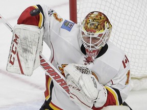 Calgary Flames goalie Brian Elliott defects a shot on goal during the third period of an NHL hockey game against the Carolina Hurricanes in Raleigh, N.C., on Feb. 26, 2017.