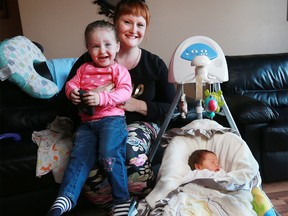 Kirsten Muldoon holds her daughter Roisin as her newborn son Killian sleeps in their Calgary home on Thursday February 2, 2017. All three share the same birth date of January 31. GAVIN YOUNG/POSTMEDIA