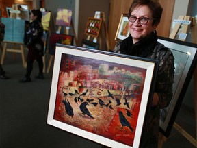 Calgary artist Natalie Kurzuk holds her painting that was stolen and then recovered by another artist in Saskatchewan.  GAVIN YOUNG/POSTMEDIA NETWORK