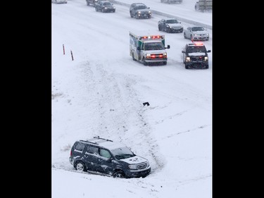 Emergency workers deal with a multi-car collision on Deerfoot Trail at Southland Drive on Sunday February 5, 2017. At least 10 cars were involved in several different accidents at the same location.